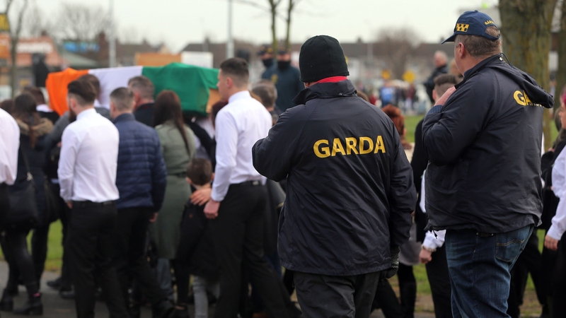A number of men in white shirts and black ties escorted Vincent Ryan's coffin as gardaí looked on