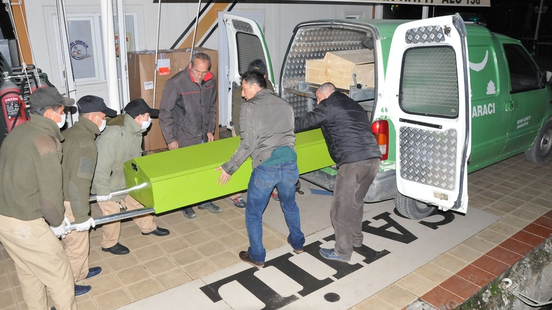 A body in a coffin is removed from the scene in Turkey