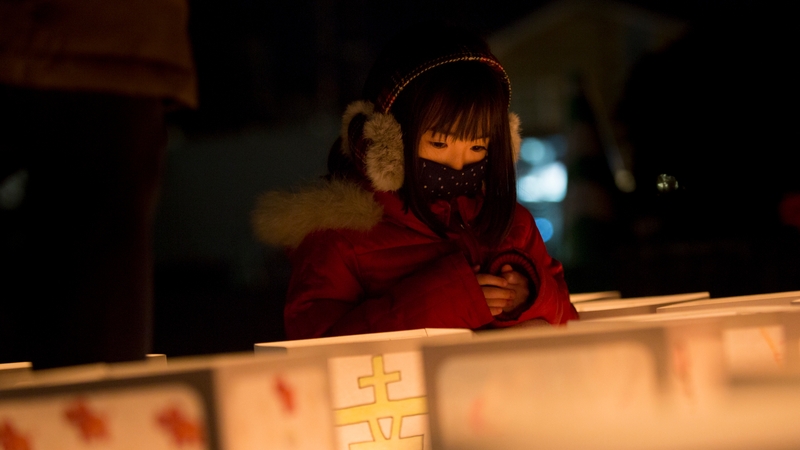 A girl looks at paper lanterns at Natori City Office to mark the fifth anniversary of the earthquake and tsunami which claimed the lives of 15,894
