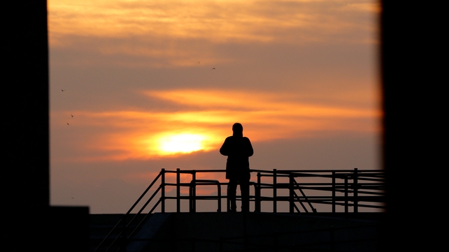 A man stands alone on a coastal levee in the coastal district of Sendai