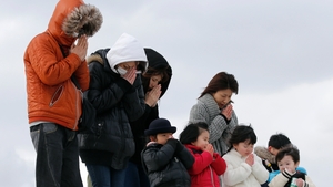 People offer a minute of silence for the victims at Abraham