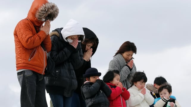 People offer a minute of silence for the victims at Abraham