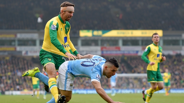 Sergio Aguero is challenged by Gary O'Neill