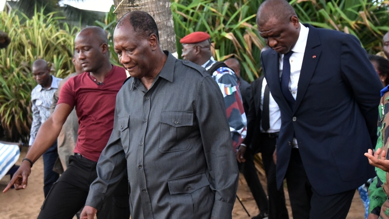 Ivorian president Alassane Ouattara (centre) and Interior Minister Ahmed Bakayoko (right) visit the beach resort