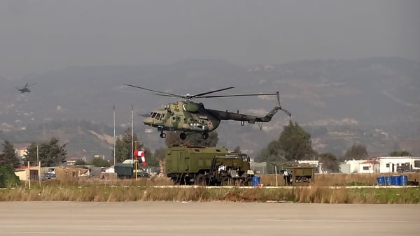 A military helicopter is seen at the Russian Hmeimim military base in Latakia province