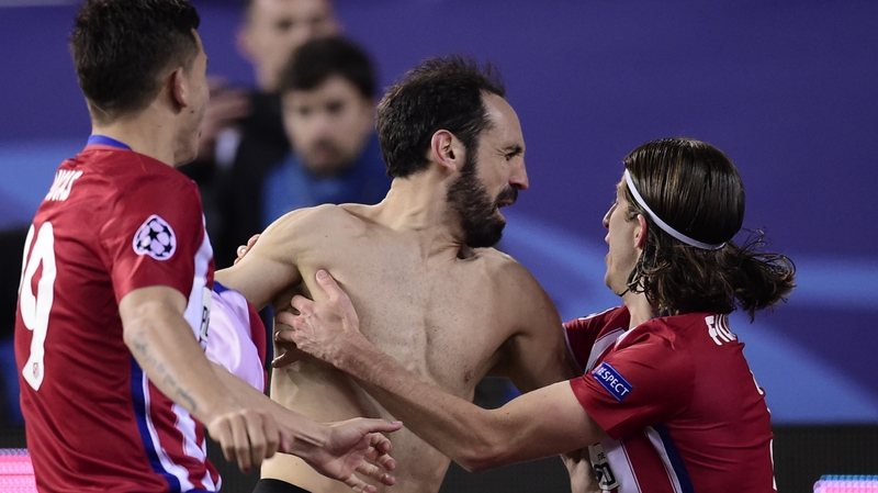Atletico Madrid's defender Juanfran celebrates with teammates after kicking the winning penalty