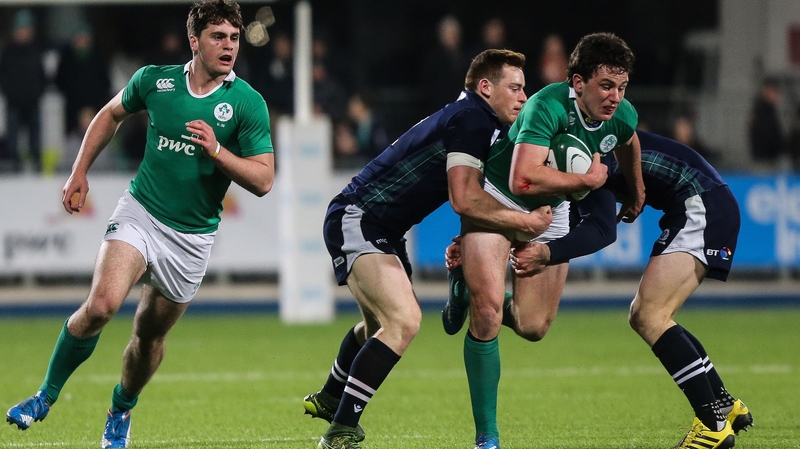 Ireland's Brett Connon is tackled by George Taylor and Tom Galbraith of Scotland
