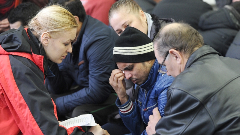A relative of a passenger on board the flydubai craft is comforted by an emergency psychologist