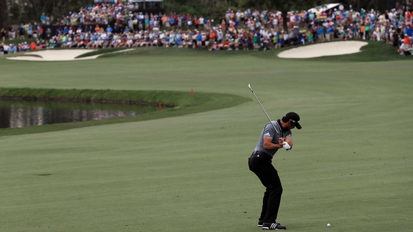 Jason Day plays an approach shot on the sixth hole