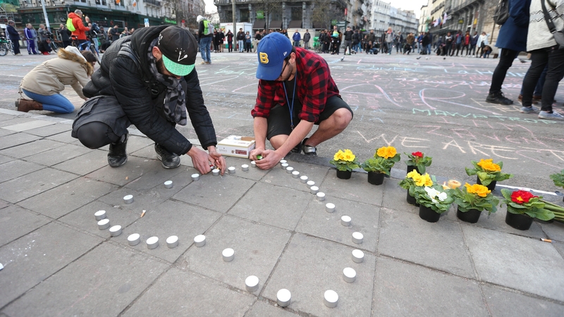 Candles and flowers are left outside the stock exchange building in Brussels in tribute to the victims of the bomb attacks