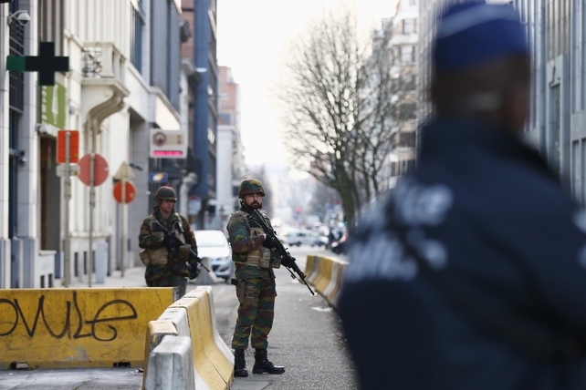 Soldiers and police officers stand guard outside EU Commission Headquarters