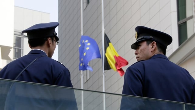 Japanese policemen stand guard outside the Belgian Embassy in Tokyo, Japa
