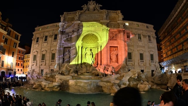 A Belgian flag is displayed on the Trevi Fountain in Rome