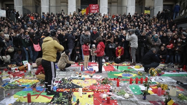 People observe a one minute's silence at the Place De La Bourse in honour of the victims