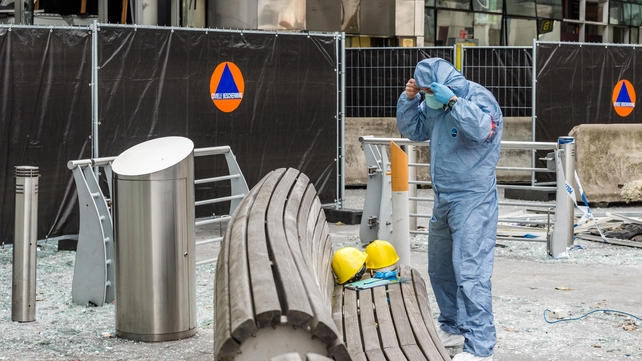 A forensics officer prepares himself before beginning work at the airport