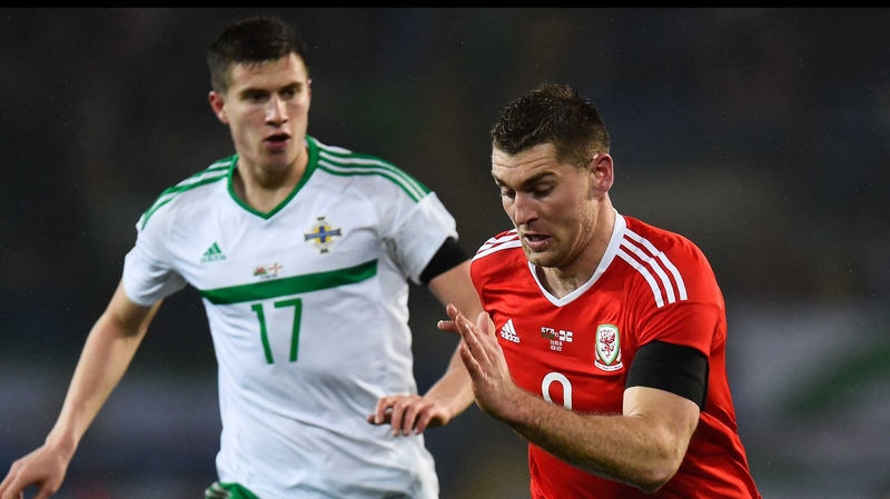 Northern Ireland's Paddy McNair tracks Sam Vokes of Wales during Thursday night's friendly