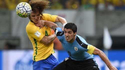 Luis Suarez (R) battles with David Luiz