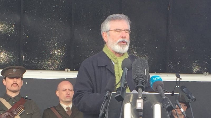 The Sinn Féin president Gerry Adams addresses the crowds at Milltown Cemetery