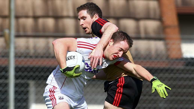 Cork's Colm O'Neill is tackled by Aidan Carr of Down