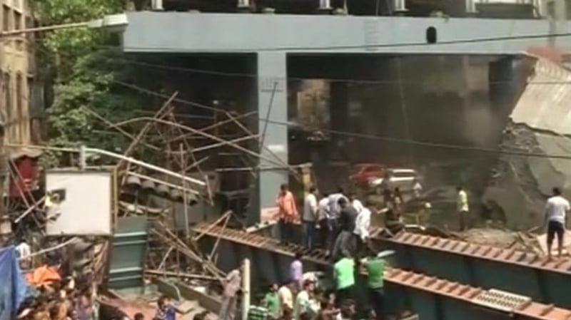 Rescuers descend on the scene where the flyover collapsed onto traffic passing below