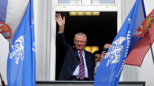 Vojislav Seselj waves to supporters from the balcony of his party headquarters in November 2014