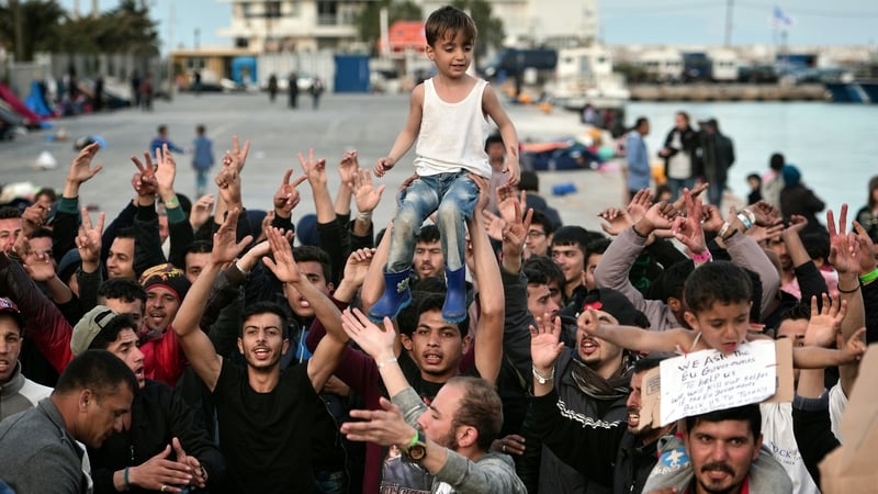 People shout 'No Turkey' at the port in Chios where refugees and migrants who broke out from Vial detention centre are camped out