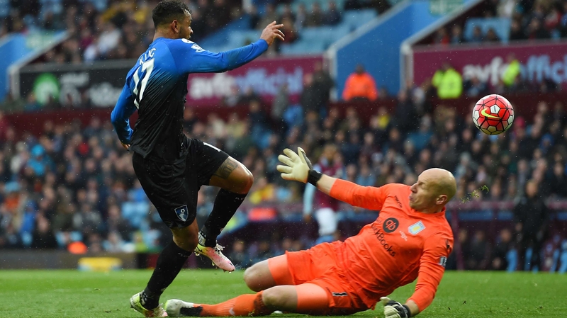 Joshua King lifts over Brad Guzan