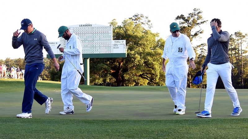 Jordan Spieth (L) and Rory McIlroy walk off the 18th green