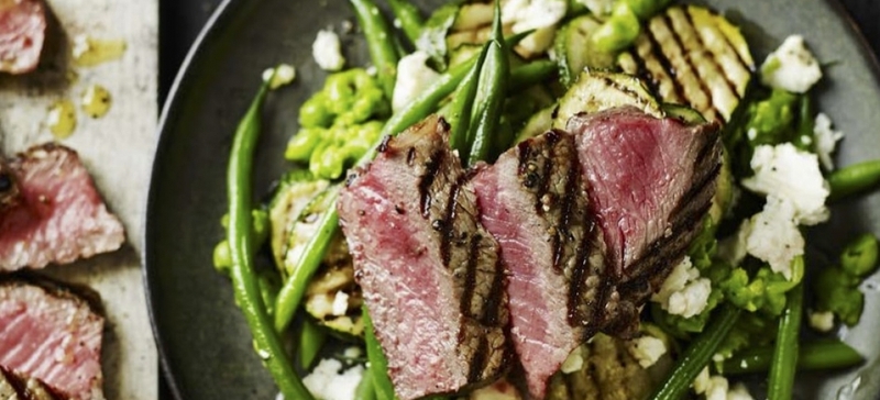 Steak with mashed pea, green bean, courgette, and feta salad