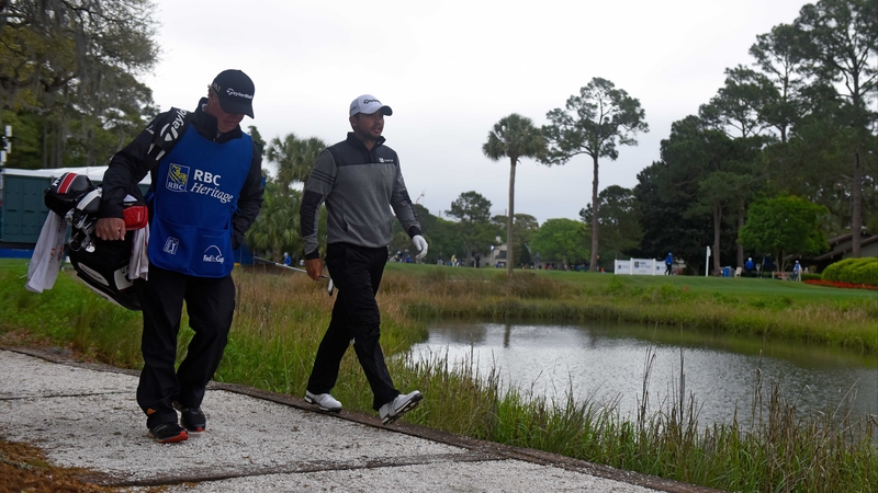 Jason Day and his caddie on their way to the 17th