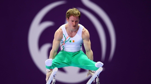 Kieran Behan on the parallel bars