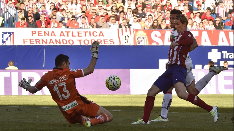 Fernando Torres slips the ball past Andres Fernandez in the Granada goal