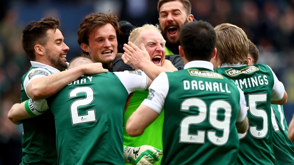 Conrad Logan is mobbed after helping steer Hibernian to the Scottish Cup final on 21 May