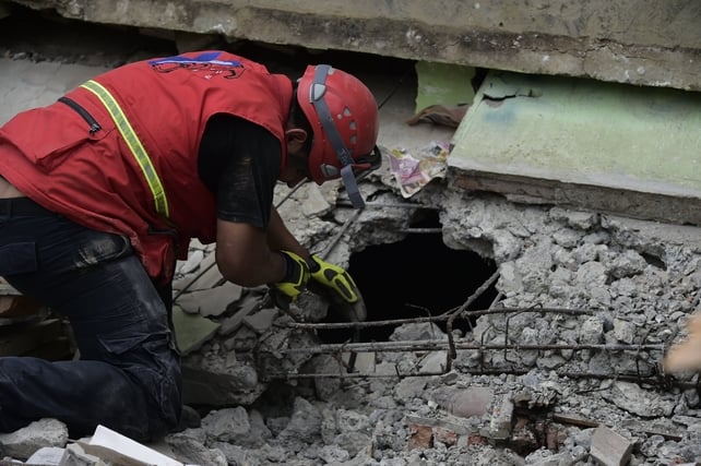 Rescue workers search the rubble in Pedernales