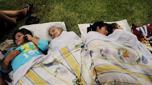 People rest in a park in Guayaquil after the earthquake destroyed buildings and sent people running from their homes