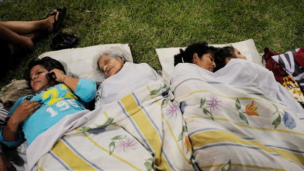 People rest in a park in Guayaquil after the earthquake destroyed buildings and sent people running from their homes