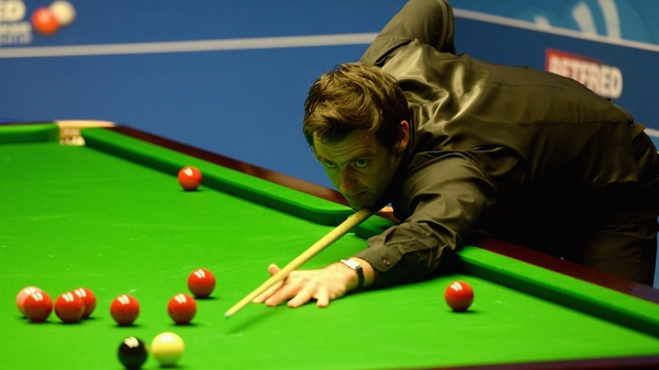 Ronnie O'Sullivan plays a shot against David Gilbert during their first round match of the 2016 Betfred World Snooker Championship