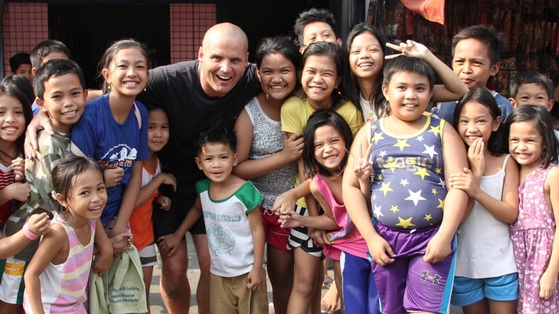 Mark Crosbie with local schoolchildren in Manila