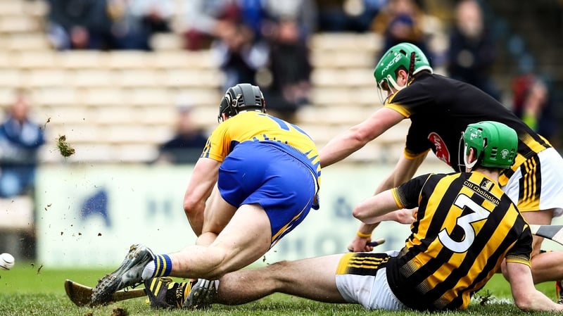 John Conlon scores Clare's first goal despite the attentions of Eoin Murphy and Joey Holden