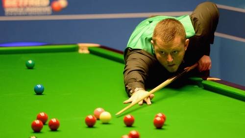 Mark Allen plays a shot against Mitchell Mann
