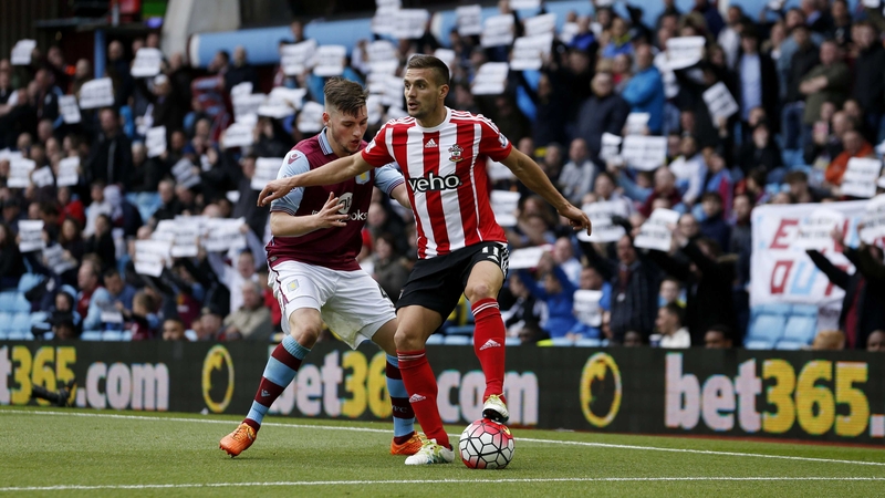 Dusan Tadic shields the ball from Aston Villa's Kevin Toner