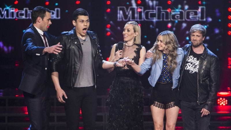 Michael Lawson is congratulated by coach Bressie as host Kathryn Thomas, runner-up Kelesa Mulcahy and her coach Kian Egan look on