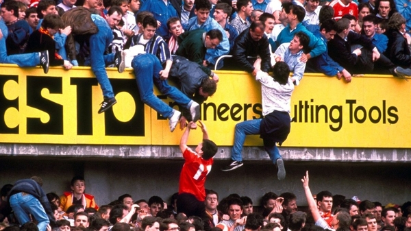 Liverpool supporters climb to safety during the FA Cup match which led to the deaths of 97 people