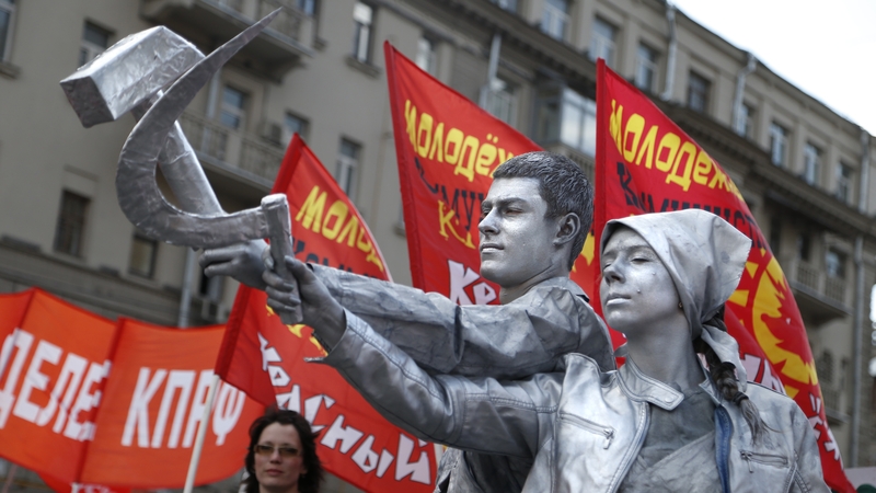 Russian Communist party supporters hold the iconic communist symbols of a hammer and sickle at a rally in Moscow