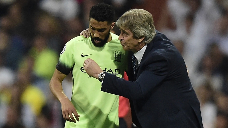 Manuel Pellegrini (R) gives instructions Gael Clichy at the Bernabeu