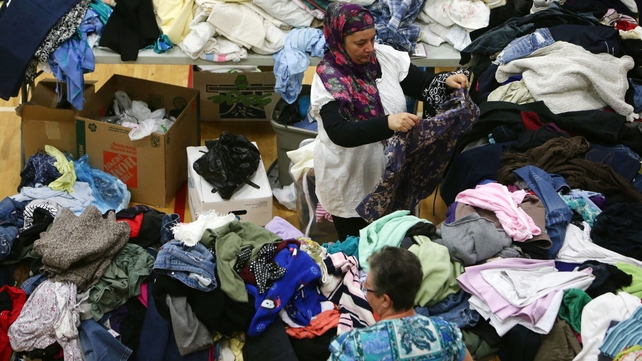 A woman picks through donated clothing and goods at a makeshift evacuee center in Lac la Biche