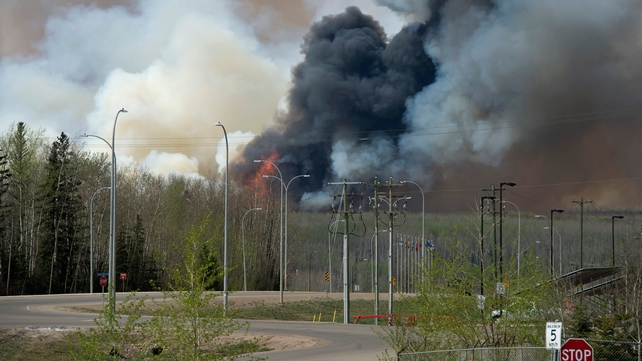 Wildfire smoke rises over the western Canadian city