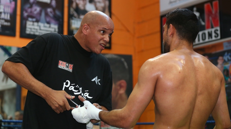 Virgil Hunter cuts the tape off Amir Khan's hands after a training session