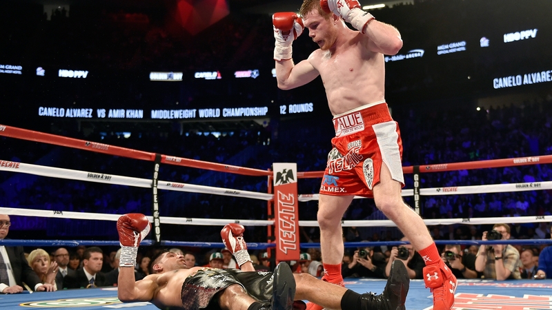 Canelo Alvarez stands over Amir Khan after delivering a knockout punch during the sixth round of their WBC middleweight title fight