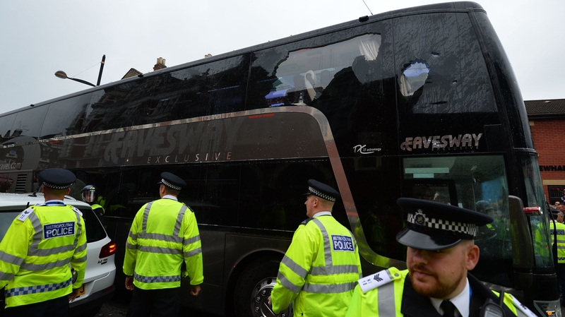 The bus carrying the Manchester United team is escorted by police after having a window smashed